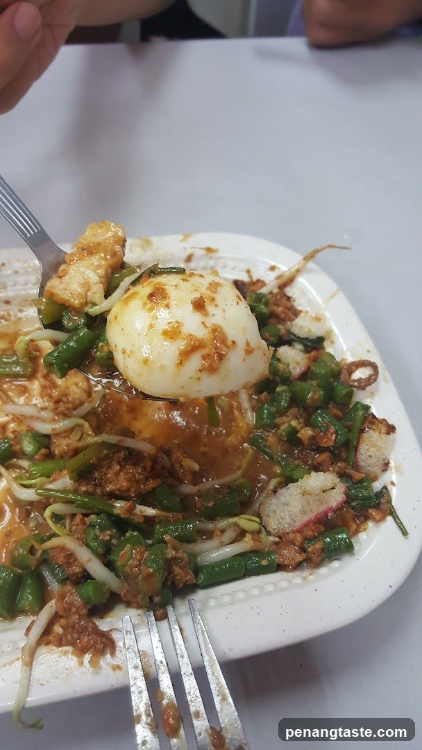 Plate of Thai-style stir-fry with egg and noodles