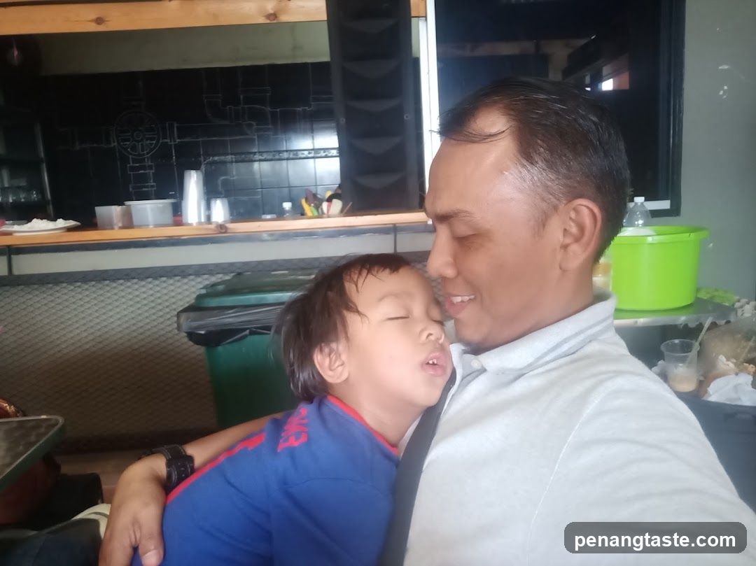 Father and sleeping child in a casual setting