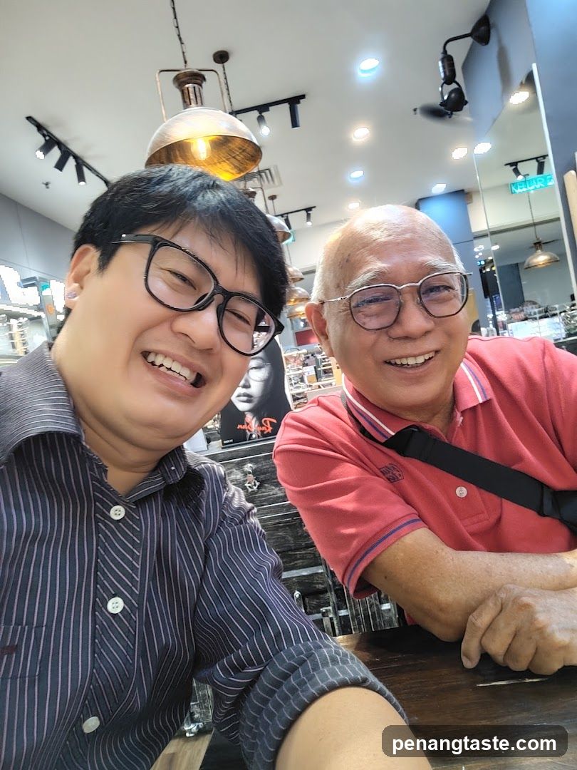 Two men smiling in a shop interior