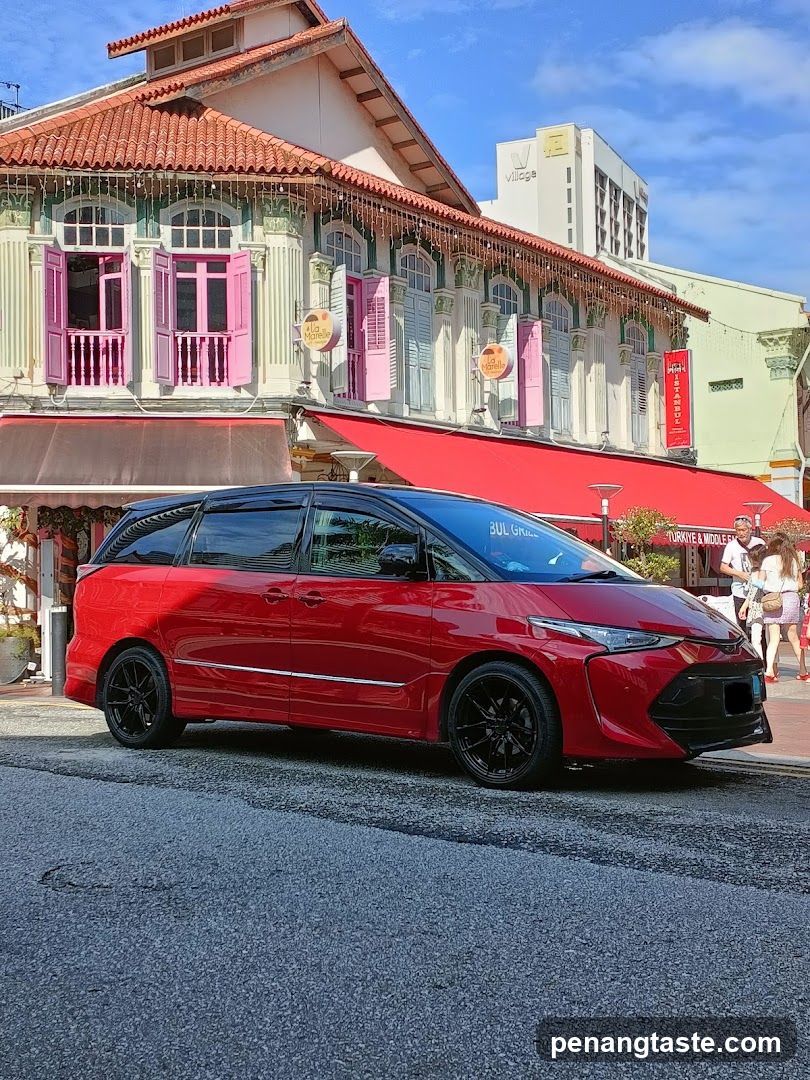 Red Minivan in Front of Colonial Building