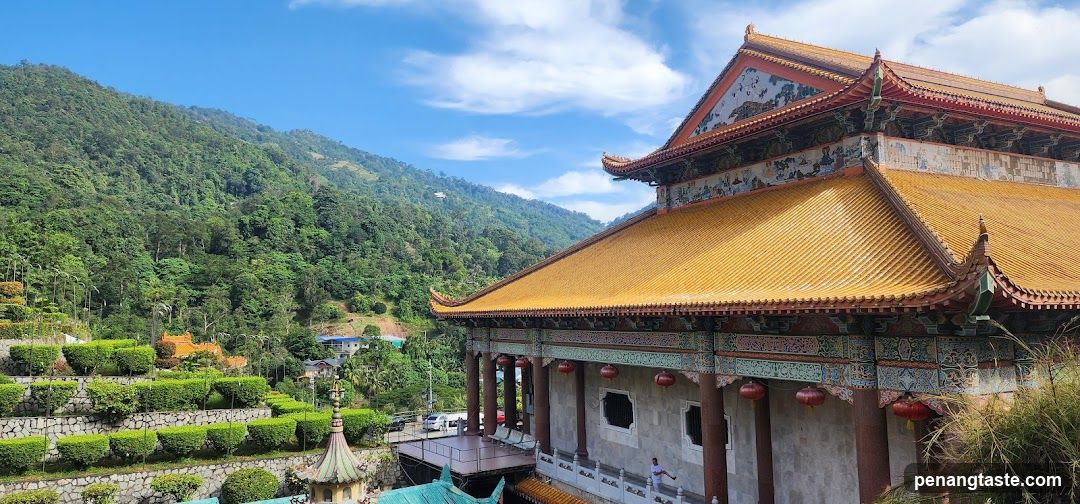 Temple with Golden Roof and Lush Green Hills