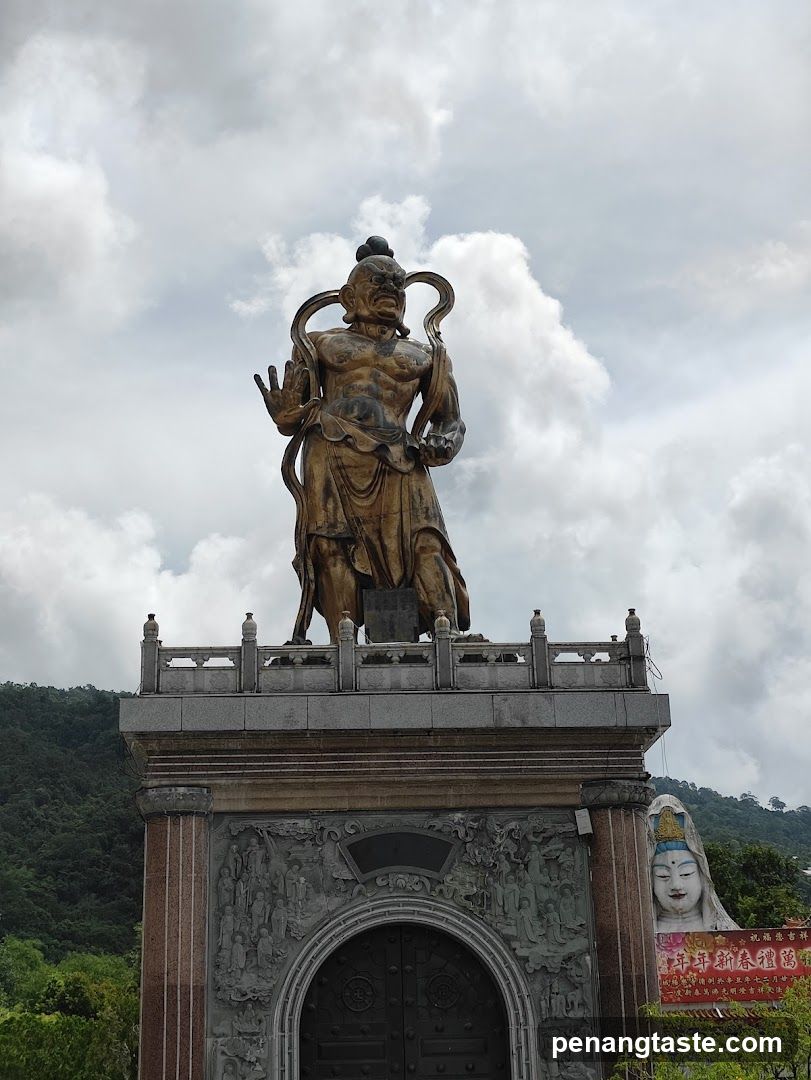 Statue of a deity on an ornate pedestal