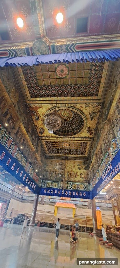 Interior of a grand hall with ornate ceiling and murals