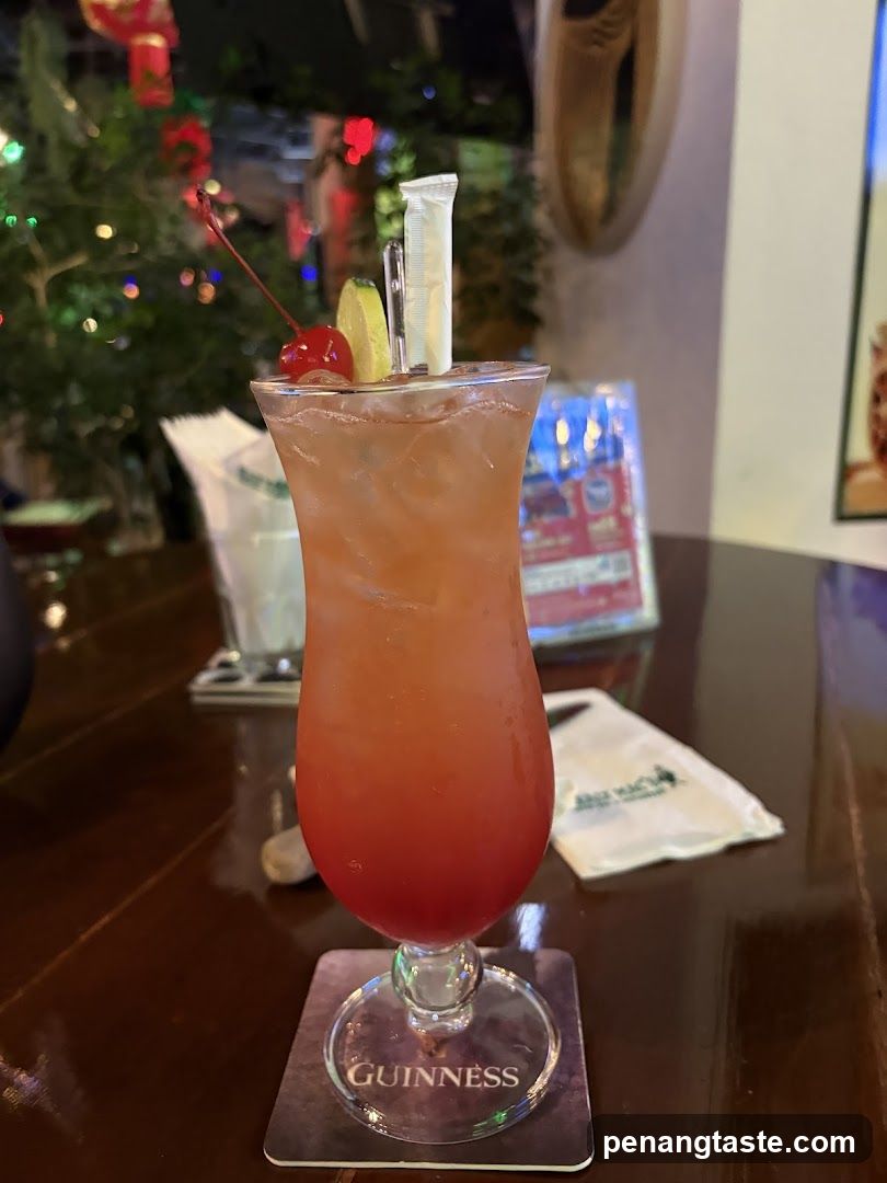 Pink Cocktail with Cherry and Lime Garnish