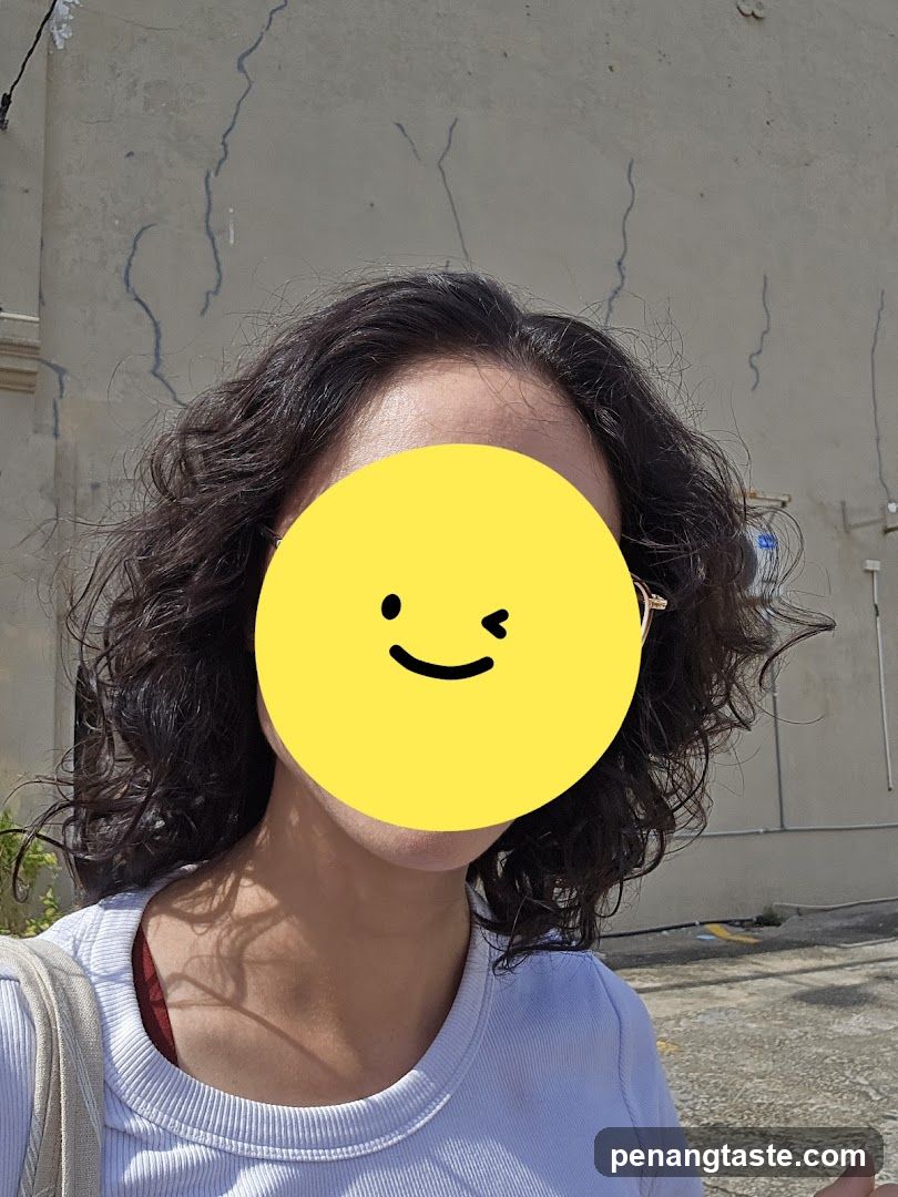 Person with Curls Outside Building