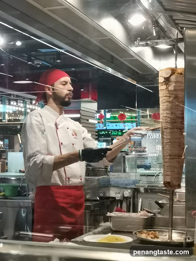 Chef preparing shawarma in a food court