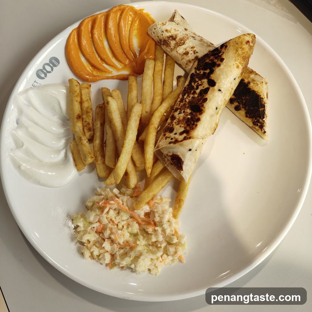 Plate of food with fries, wraps, coleslaw and sauces