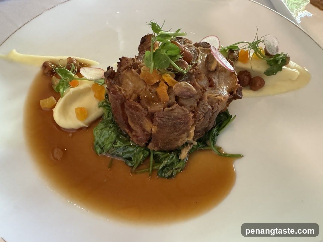Plated Meat Dish with Greens and Sauce