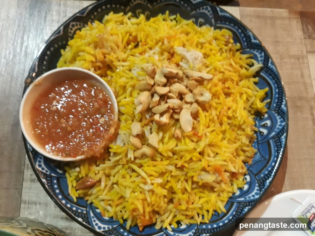 Yellow Rice Dish with Peanut Garnish and Chutney