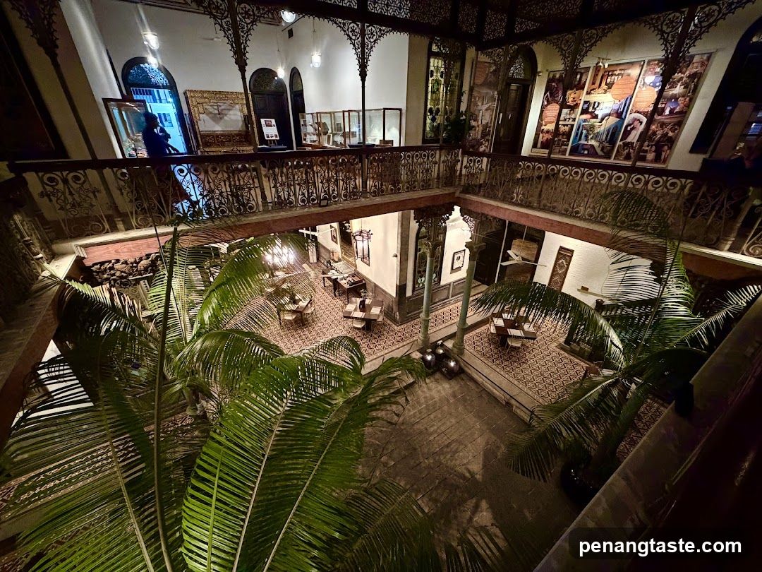 Interior atrium view with palm trees and gallery displays