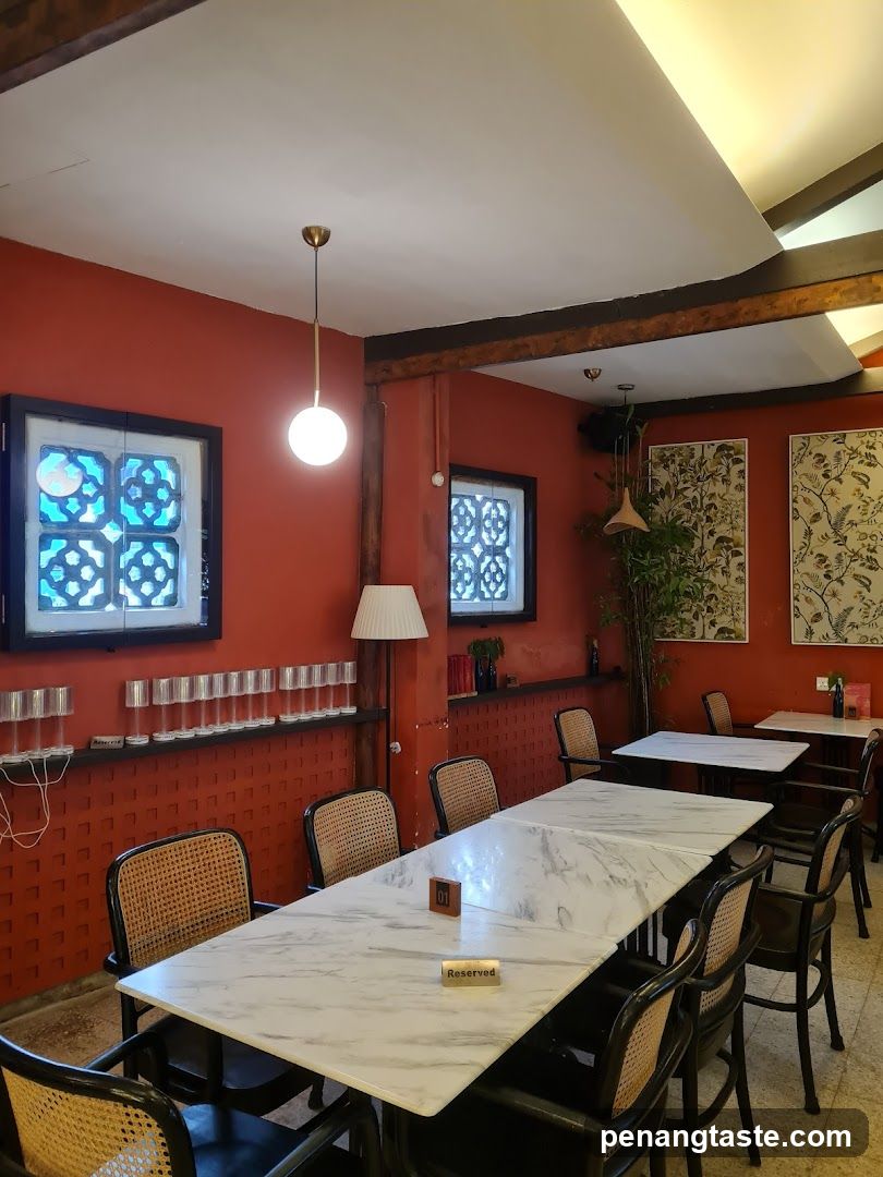 Interior of a restaurant or cafe with red walls and marble tables
