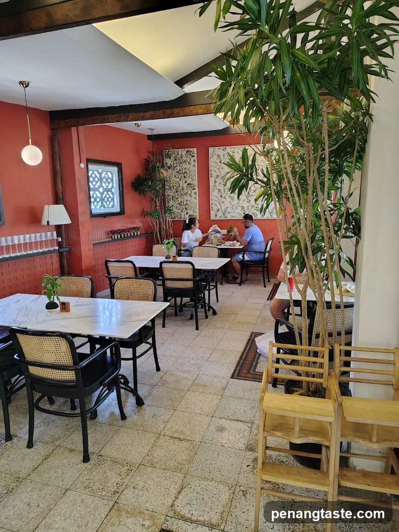 Restaurant Interior with Red Walls and Greenery