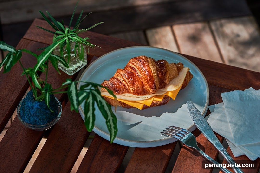Croissant Sandwich on Wooden Table