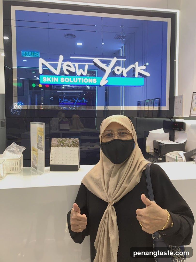 Woman giving thumbs up at New York Skin Solutions