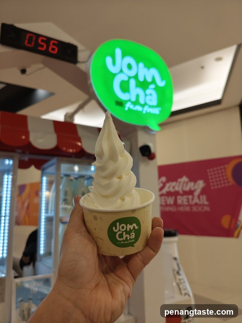 Soft serve ice cream in cup with Jom Cha sign
