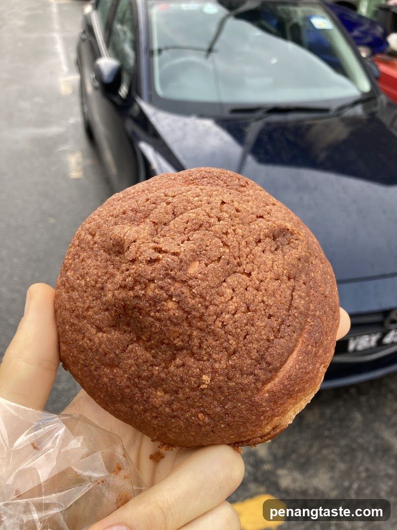 Hand Holding a Pastry Bun