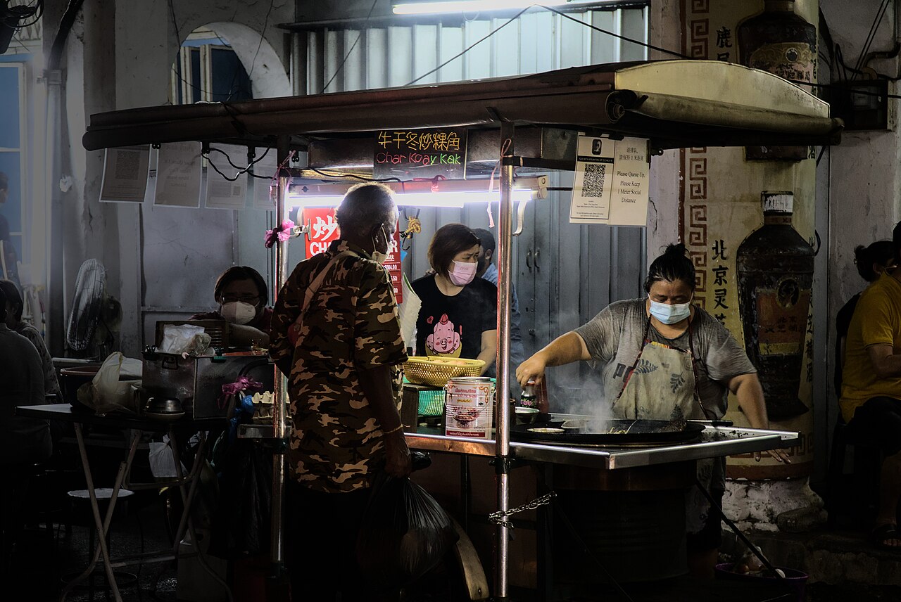 A hawker stall frying char koay kak at a George Town night hawker centre in Penang