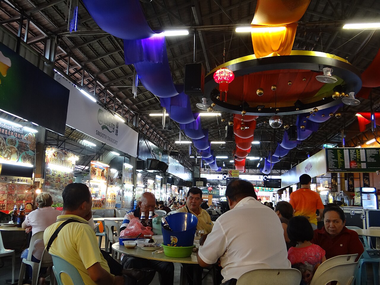 A lively George Town food court scene with diners and hawker stalls at night in Penang