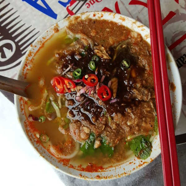 A bowl of Penang assam laksa with mackerel, mint, pineapple, and prawn paste at Air Itam market